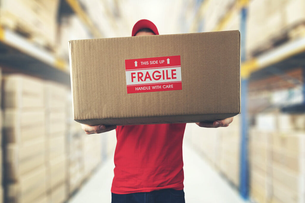 mover holding a package with fragile items