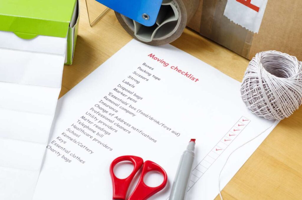 A moving checklist with some pens and scissors